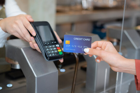 Customer use wireless credit card with EDC at cashier in restaurant.