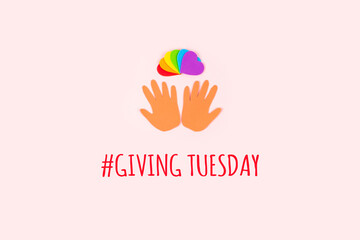 Giving tuesday concept. Minimal flat lay with text Giving Tuesday paper palms and rainbow hearts on pastel background
