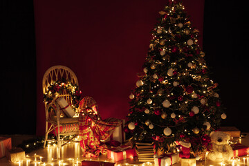 Fototapeta premium Christmas tree shines lights garlands New Year's Night Red Wall