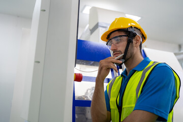Engineer inspecting and checking operating process on machine monitor.