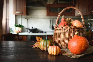 Domestic Halloween party with pumpkins on tabletop and blurred kitchen as backdrop. Home...