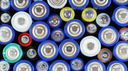 Top view of the background of AAA AA batteries and rechargeable batteries. Choice of batteries....