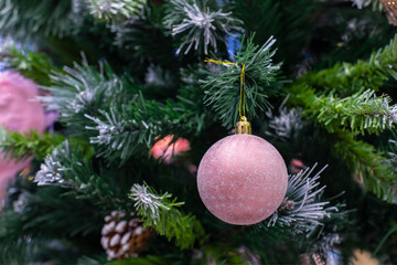 Christmas tree with matte pink ball with snowflakes. Festive Christmas background design. New year seasonal holiday, christmas decoration, ball in hoarfrost