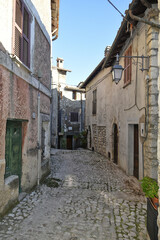 A narrow street between the old houses of Fumone, a medieval village in the province of Frosinone, Italy.