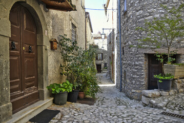 Fototapeta na wymiar A narrow street between the old houses of Fumone, a medieval village in the province of Frosinone, Italy.