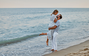 Young couple in love romantically spend time on the beach enjoying each other and vacation by the sea.