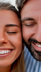 Close-up cropped image of handsome man and attractive woman smiling with closed eyes and having fun.