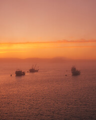 Boats in fog at sunset, in Lubec, Maine