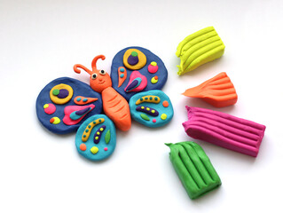 The bright butterfly made of plasticine and plasticine on a white background