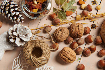 christmas decoration in rustic style and holiday background, still life on wooden backdrop, bread, nuts and other
