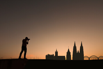 man in front of cologne city skyline