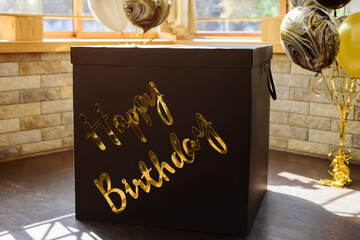 Big black gift box with golden text happy birthday