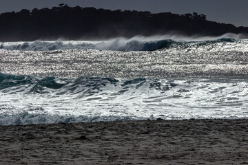 Waves breaking on the beach near the town of Carmel on the pacific coast  of California