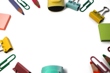 Assorted school supplies lie around. On a white background pencil felt-tip pen paper clip paper clip