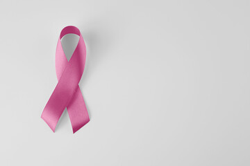 Sweet pink ribbon shape on pink background paper for breast cancer awareness symbol to promote in...