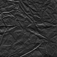Black vintage and old looking crumpled paper background. Retro cardboard texture. Grunge paper for drawing. Ancient book page. Present wrapping.