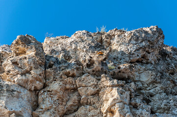 The edge of a stone precipice and the blue sky.