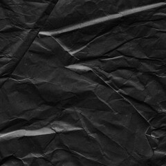 Black vintage and old looking crumpled paper background. Retro cardboard texture. Grunge paper for drawing. Ancient book page. Present wrapping.