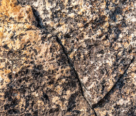 Dark gray stone with orange-yellow interspersed for background.