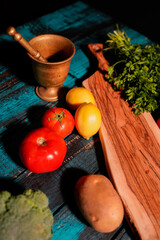 tomato potato pepper mortar on wooden table
