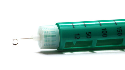 a drop of insulin injector pen on the tip of the needle, close-up, white background, isolated