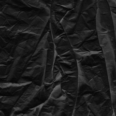 Black vintage and old looking crumpled paper background. Retro cardboard texture. Grunge paper for drawing. Ancient book page. Present wrapping.