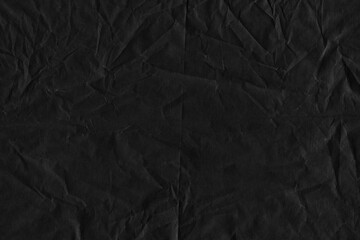 Black vintage and old looking crumpled paper background. Retro cardboard texture. Grunge paper for drawing. Ancient book page. Present wrapping.