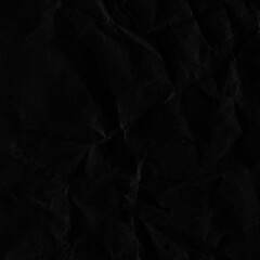 Black vintage and old looking crumpled paper background. Retro cardboard texture. Grunge paper for drawing. Ancient book page. Present wrapping.