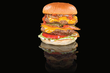 Delicious Double cheeseburger with beef, cheese, tomatoes, lettuce and sauce,