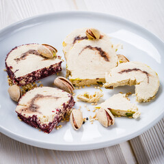 Oriental delight halva with pistachios on white plate