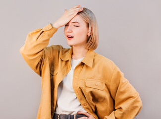 Gosh why me. Portrait of unhappy displeased and annoyed young arrogant woman facepalming with...