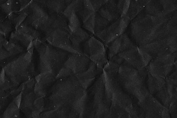 Black vintage and old looking crumpled paper background. Retro cardboard texture. Grunge paper for drawing. Ancient book page. Present wrapping.