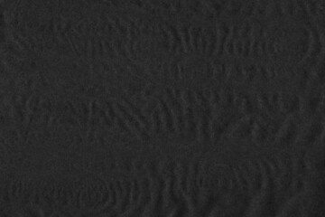 Black vintage and old looking crumpled paper background. Retro cardboard texture. Grunge paper for drawing. Ancient book page. Present wrapping.