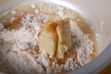 Butter, sugar and flour in a bowl. Kneading the dough. Levington cake, stages of preparation.