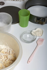Dough in a bowl. Nearby is a collapsible baking dish. Levington cake, stages of preparation.