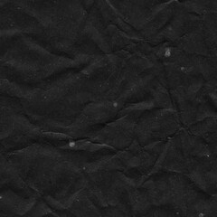 Fototapeta premium Black vintage and old looking crumpled paper background. Retro cardboard texture. Grunge paper for drawing. Ancient book page. Present wrapping.