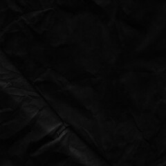 Fototapeta premium Black vintage and old looking crumpled paper background. Retro cardboard texture. Grunge paper for drawing. Ancient book page. Present wrapping.
