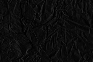Black vintage and old looking crumpled paper background. Retro cardboard texture. Grunge paper for drawing. Ancient book page. Present wrapping.