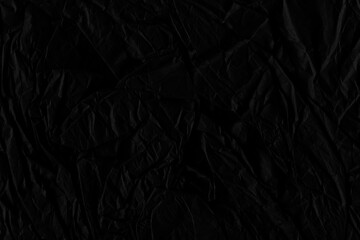 Black vintage and old looking crumpled paper background. Retro cardboard texture. Grunge paper for drawing. Ancient book page. Present wrapping.