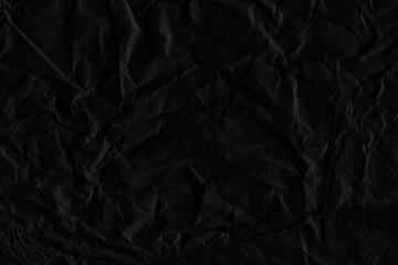 Black vintage and old looking crumpled paper background. Retro cardboard texture. Grunge paper for drawing. Ancient book page. Present wrapping.