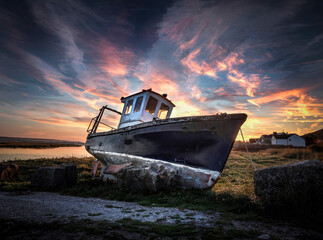 An old fishing boat in the cockle picking village of Penclawdd in Swansea, South Wales, UK
