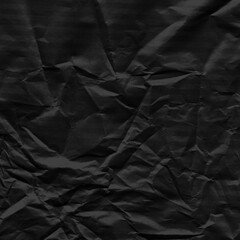 Black vintage and old looking crumpled paper background. Retro cardboard texture. Grunge paper for drawing. Ancient book page. Present wrapping.