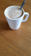 Brewed coffee. Porcelain cup with coffee. Hot coffee drink