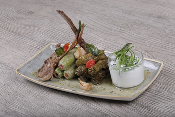 Dish Stuffed eggplant Beside tomato sauce and rice and minced meat with Lentil soup dish And Rocca Salad serve with fried bread