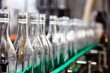 Factory for the production of alcoholic beverages. Bottles of vodka on the conveyor.