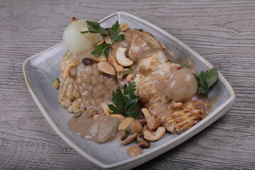 Fish fillet With the grains Dough sauce And chickpeas Decorated With green parsley And cooked onions