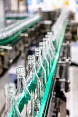 Factory for the production of alcoholic beverages. Bottles of vodka on the conveyor.