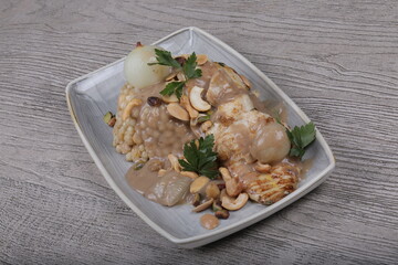 Fish fillet With the grains Dough sauce And chickpeas Decorated With green parsley And cooked onions