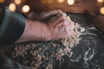 Dough preparation in christmas bakery
Dough preparation with flour, butter and egg for homemade christmas cookies. Concept for baking at home with fresh ingredients and golden bokeh.