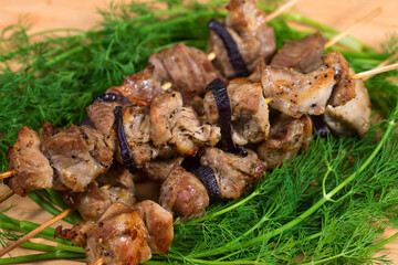 grill meat with green on wooden plate